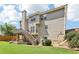Side angle of home's exterior showing large backyard, deck, and chimney at 2851 Weatherstone Se Cir, Conyers, GA 30094