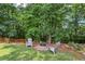 Landscaped backyard with cozy fire pit area at 2851 Weatherstone Se Cir, Conyers, GA 30094