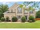 Charming two-story home with manicured lawn and decorative shrubs in a suburban neighborhood with blue skies at 2851 Weatherstone Se Cir, Conyers, GA 30094
