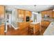Well-lit kitchen with stainless steel appliances, wood cabinets, granite counters, and hardwood floors at 2851 Weatherstone Se Cir, Conyers, GA 30094