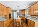 Bright kitchen featuring wood cabinets, granite countertops, stainless steel appliances, and a functional center island at 2851 Weatherstone Se Cir, Conyers, GA 30094