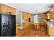 Spacious kitchen with granite countertops, wood cabinets, stainless steel appliances, and hardwood flooring at 2851 Weatherstone Se Cir, Conyers, GA 30094