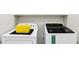 Modern laundry room with side by side white washer and dryer units at 2851 Weatherstone Se Cir, Conyers, GA 30094