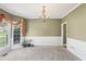 Bright living room featuring large bay windows, neutral carpet, and chandelier at 2851 Weatherstone Se Cir, Conyers, GA 30094