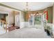 Bright living room featuring large bay windows, neutral carpet, and chandelier at 2851 Weatherstone Se Cir, Conyers, GA 30094