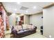 Comfortable basement living area with a soft leather couch, speakers, and access to the bar area at 2851 Weatherstone Se Cir, Conyers, GA 30094