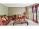 Cozy living room with plush sofas, decorative pillows, and large window at 2851 Weatherstone Se Cir, Conyers, GA 30094