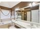 Relaxing main bathroom featuring double vanity, soaking tub, and a large mirror at 2851 Weatherstone Se Cir, Conyers, GA 30094