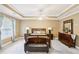 Spacious main bedroom with neutral color palette, tray ceilings, and lots of natural light at 2851 Weatherstone Se Cir, Conyers, GA 30094