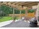 Comfortable covered porch with ceiling fan and privacy curtains overlooking the backyard at 2851 Weatherstone Se Cir, Conyers, GA 30094