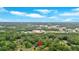 An aerial view shows this house nestled in a mature forest near an urban area under a bright blue sky at 4477 Timber Ridge Dr, Douglasville, GA 30135