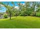 Lush backyard featuring mature trees and expansive green lawn at 4477 Timber Ridge Dr, Douglasville, GA 30135