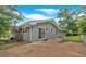 Exterior view of home with backyard concrete patio and sliding glass doors at 4477 Timber Ridge Dr, Douglasville, GA 30135