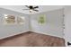 Bedroom with wood-look floors, white walls, and views of the surrounding yard at 4477 Timber Ridge Dr, Douglasville, GA 30135
