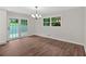 Bright dining area with wood-look flooring, modern lighting fixture, and access to the backyard at 4477 Timber Ridge Dr, Douglasville, GA 30135