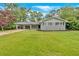 Single-story home with grey brick, a well-manicured lawn, and a covered carport at 4477 Timber Ridge Dr, Douglasville, GA 30135