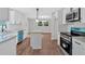 Modern kitchen featuring granite counters, white cabinets, and stainless steel appliances at 4477 Timber Ridge Dr, Douglasville, GA 30135