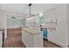 Bright kitchen with white cabinets, granite countertops, and stainless steel appliances, plus view to Gathering room at 4477 Timber Ridge Dr, Douglasville, GA 30135