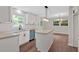 Bright kitchen with white cabinets, granite countertops, and stainless steel appliances, plus view to eat in dining area at 4477 Timber Ridge Dr, Douglasville, GA 30135