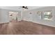 Open-concept living room with wood-look floors, a ceiling fan, and lots of natural light at 4477 Timber Ridge Dr, Douglasville, GA 30135