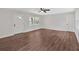 Bright living room with wood-look floors, a ceiling fan, and white trim at 4477 Timber Ridge Dr, Douglasville, GA 30135