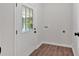 Mud room with wood-look floors, access to backyard, and washer and dryer hookups at 4477 Timber Ridge Dr, Douglasville, GA 30135