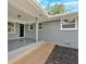 Covered patio with painted brick, outdoor lighting, and wheelchair access ramp at 4477 Timber Ridge Dr, Douglasville, GA 30135