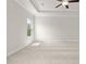 Spacious bedroom with tray ceiling, neutral carpet, large window, and a ceiling fan at 631 Skytop Dr, Cumming, GA 30040