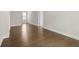 Neutral hallway features hard wood flooring, white trim, and white doors with a window view at 631 Skytop Dr, Cumming, GA 30040