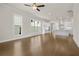 Open-concept living room and kitchen boast hardwood floors, white cabinets, and a large center island at 631 Skytop Dr, Cumming, GA 30040