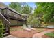 Backyard features a brick walkway, lounge chairs, and a deck above, great for outdoor relaxation at 2072 Castleway Ne Dr, Atlanta, GA 30345