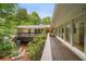 Outdoor deck and backyard featuring lush landscaping, perfect for entertaining at 2072 Castleway Ne Dr, Atlanta, GA 30345