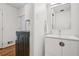 Bright bathroom with a modern vanity, framed mirror, and in-unit washer and dryer at 2072 Castleway Ne Dr, Atlanta, GA 30345