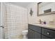 Full bathroom with decorative shower curtain, neutral vanity, and custom art at 2072 Castleway Ne Dr, Atlanta, GA 30345