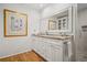 Bathroom featuring double sinks, granite countertop, framed mirror, and tiled shower at 2072 Castleway Ne Dr, Atlanta, GA 30345