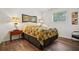 Bedroom with hardwood floors, a window, and a bed with colorful linens at 2072 Castleway Ne Dr, Atlanta, GA 30345