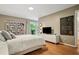 Bedroom with hardwood floors, large window, access to the deck, and a media center at 2072 Castleway Ne Dr, Atlanta, GA 30345