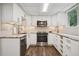 Modern kitchen featuring white cabinetry, stainless steel appliances, and stone countertops at 2072 Castleway Ne Dr, Atlanta, GA 30345
