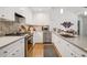 Modern kitchen with stainless steel appliances, light countertops, and natural lighting at 2072 Castleway Ne Dr, Atlanta, GA 30345