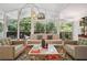 Bright living room with floor to ceiling windows and mid-century modern decor at 2072 Castleway Ne Dr, Atlanta, GA 30345