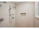 Tiled shower with multiple shower heads and custom inset storage at 2072 Castleway Ne Dr, Atlanta, GA 30345