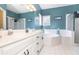 Bright bathroom features a double vanity, soaking tub, and glass-enclosed shower at 3785 Glen Ian Dr, Loganville, GA 30052