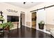 Cozy living room features dark wood floors, neutral walls, and a white barn door at 3785 Glen Ian Dr, Loganville, GA 30052