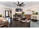 Inviting living room with stone fireplace, dark wood floors, and comfortable seating at 3785 Glen Ian Dr, Loganville, GA 30052
