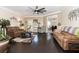Spacious living room with dark wood floors, neutral walls, and modern ceiling fan at 3785 Glen Ian Dr, Loganville, GA 30052