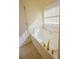 Bathroom featuring a soaking tub with gold fixtures and a window with natural light at 1305 Bramlett Forest Trail Southeast Trl, Lawrenceville, GA 30045