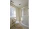 Bathroom with walk-in shower, toilet, and window for natural light at 1305 Bramlett Forest Trail Southeast Trl, Lawrenceville, GA 30045
