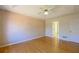 Spacious bedroom featuring hardwood floors, a ceiling fan, and a tray ceiling at 1305 Bramlett Forest Trail Southeast Trl, Lawrenceville, GA 30045