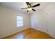 Comfortable bedroom with hardwood floors, a window, a ceiling fan, and a closet at 1305 Bramlett Forest Trail Southeast Trl, Lawrenceville, GA 30045
