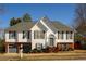 Charming two-story home boasts a brick-accented facade and a well-manicured lawn with mature landscaping at 1305 Bramlett Forest Trail Southeast Trl, Lawrenceville, GA 30045
